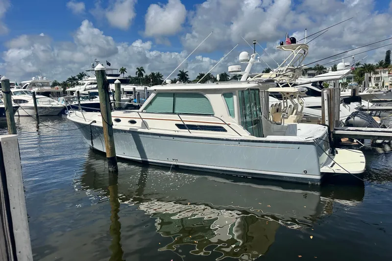 The Image of 2011 Back Cove Downeast 37 yacht docked at marina under blue sky. - 0