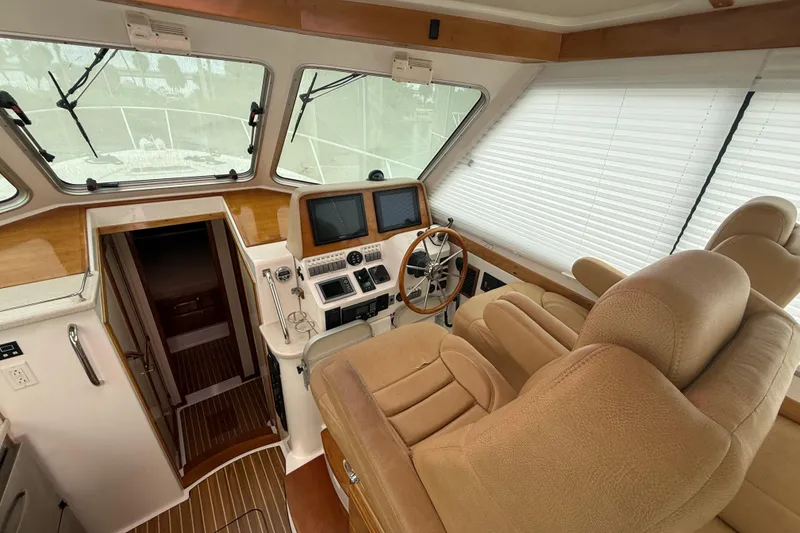 Slide: The Image of Helm of 2011 Back Cove Downeast 37 with navigation screens and controls. - 10