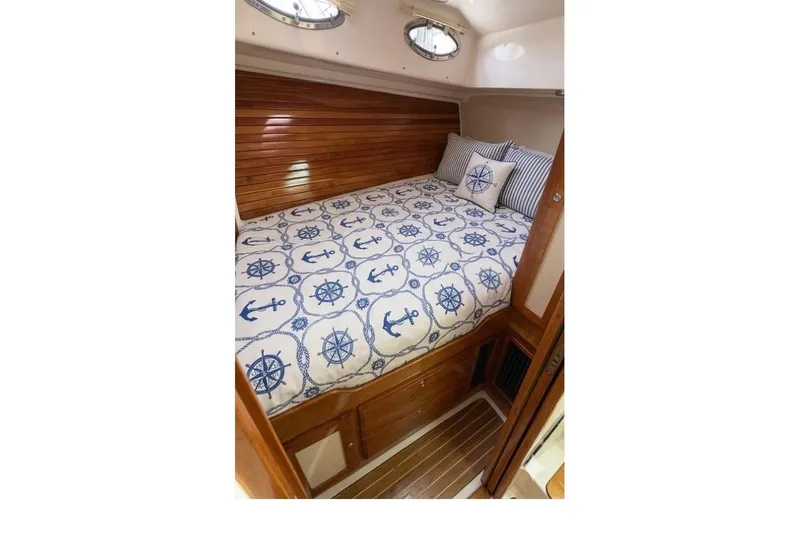 Slide: The Image of Cozy cabin interior of 2011 Back Cove Downeast 37 with nautical-themed bedding. - 16