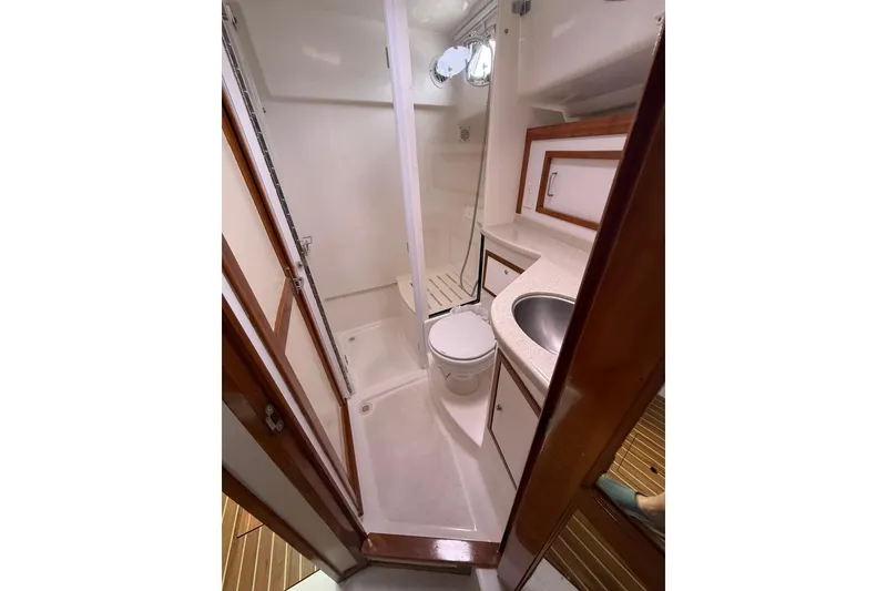 Slide: The Image of 2011 Back Cove Downeast 37 yacht bathroom with shower, sink, and toilet. - 17