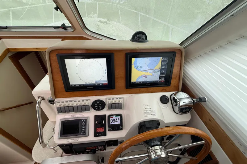 Slide: The Image of Luxurious 2011 Back Cove Downeast 37 yacht kitchen with wood cabinetry and stainless steel appliances. - 18