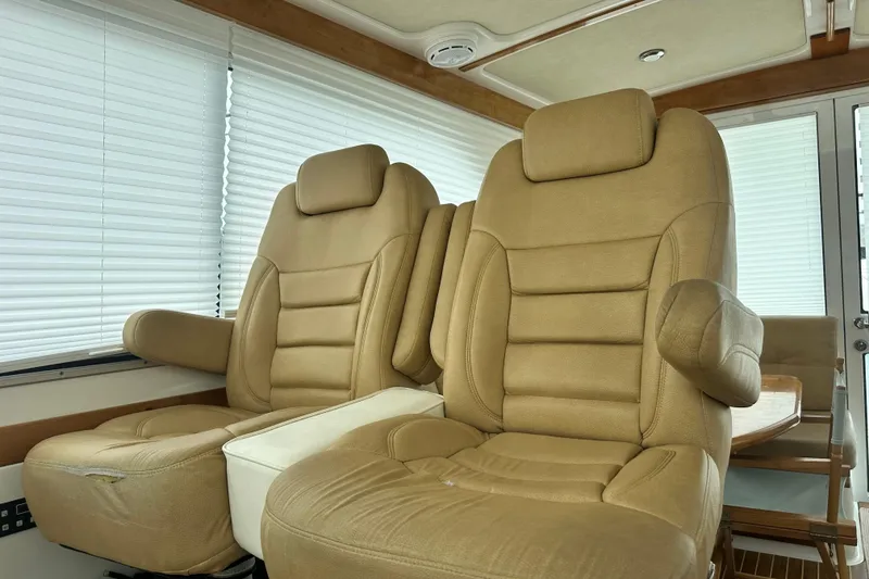 Slide: The Image of 2011 Back Cove Downeast 37 boat docked, featuring sleek design and spacious deck area. - 2