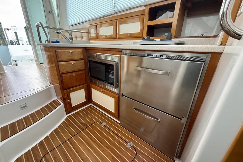 Slide: The Image of Striped cushioned seating on a 2011 Back Cove Downeast 37 boat deck. - 20
