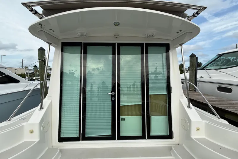 Slide: The Image of 2011 Back Cove Downeast 37 boat with glass doors at dock. - 23
