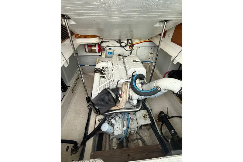 Slide: The Image of Battery compartment of a 2011 Back Cove Downeast 37 boat, featuring organized wiring and secure battery boxes. - 25