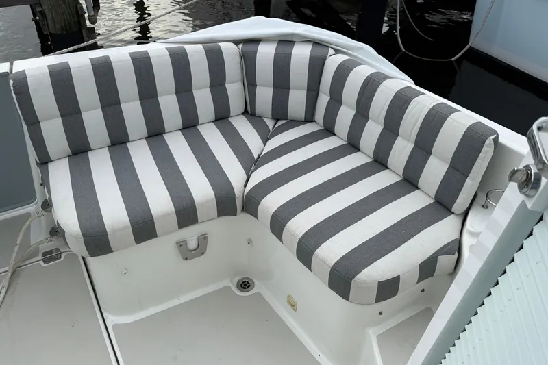 Slide: The Image of Luxurious helm of 2011 Back Cove Downeast 37 with plush seating and advanced navigation. - 6