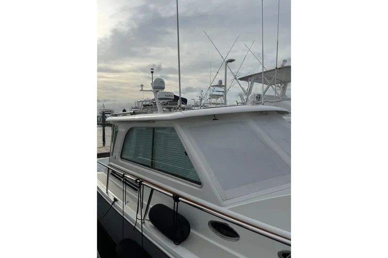 Slide: The Image of Interior of 2011 Back Cove Downeast 37 boat with wood flooring and helm seat. - 7