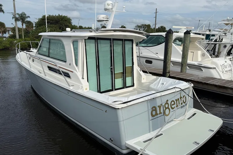 Slide: The Image of Control panel of a 2011 Back Cove Downeast 37 boat with navigation displays. - 9