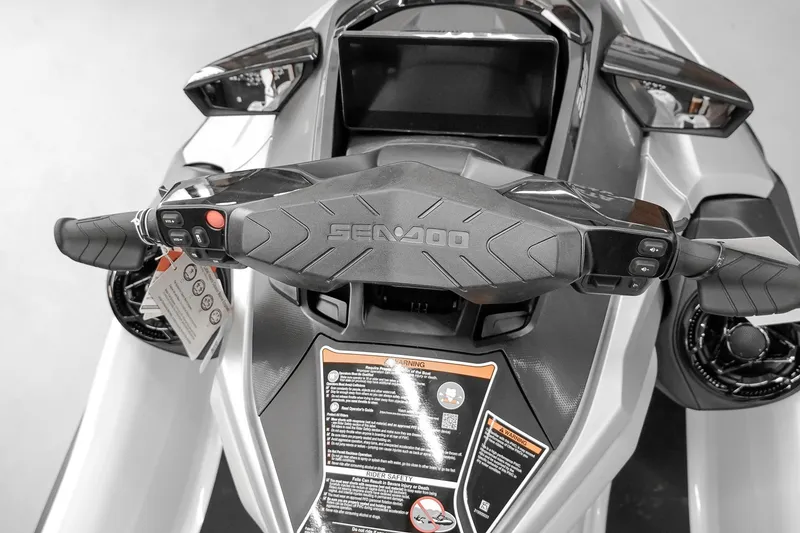 Slide: The Image of 2026 Sea-Doo GTX Limited 325 dashboard and handlebars, featuring advanced controls and safety warnings. - 11