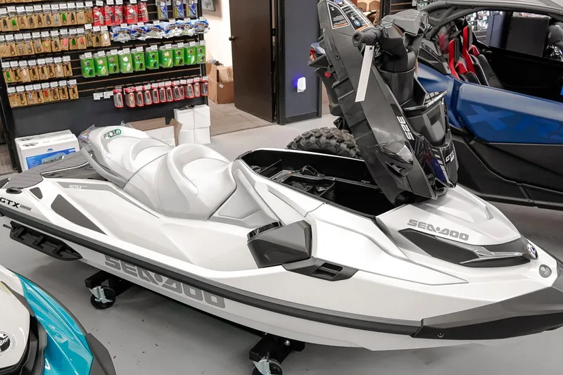 Slide: The Image of 2026 Sea-Doo GTX Limited 325 jet ski displayed in a showroom with accessories. - 21