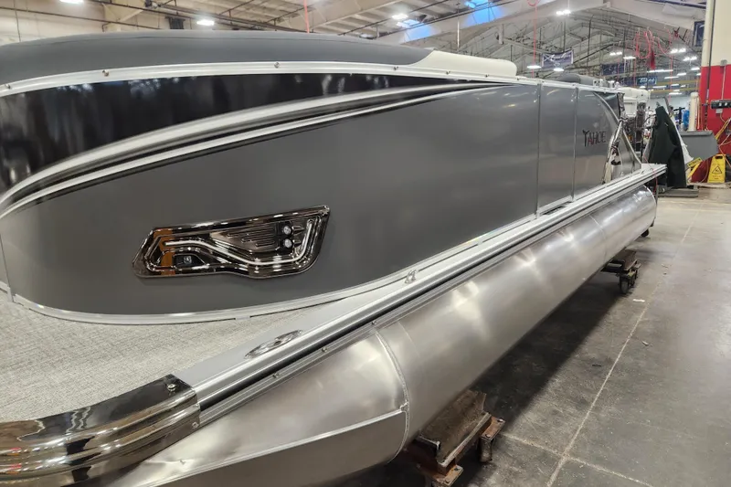 The Image of 2026 Tahoe Pontoon 1985 LTZ Cruise in a showroom, showcasing sleek design and modern features. - 1