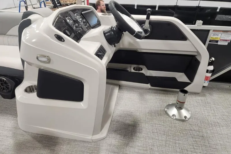 Slide: The Image of 2026 Tahoe Pontoon 1985 LTZ Cruise helm with steering wheel and control panel. - 4
