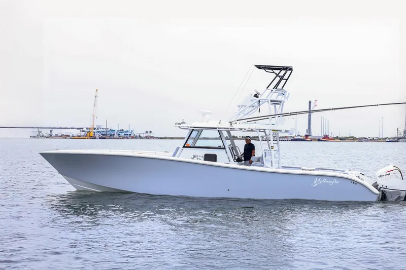 The Image of 2020 Yellowfin 42 Offshore boat cruising in a harbor with industrial background. - 1