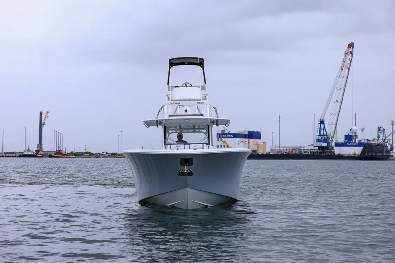 Slide: The Image of 2020 Yellowfin 42 Offshore boat in harbor, with industrial cranes in the background. - 14