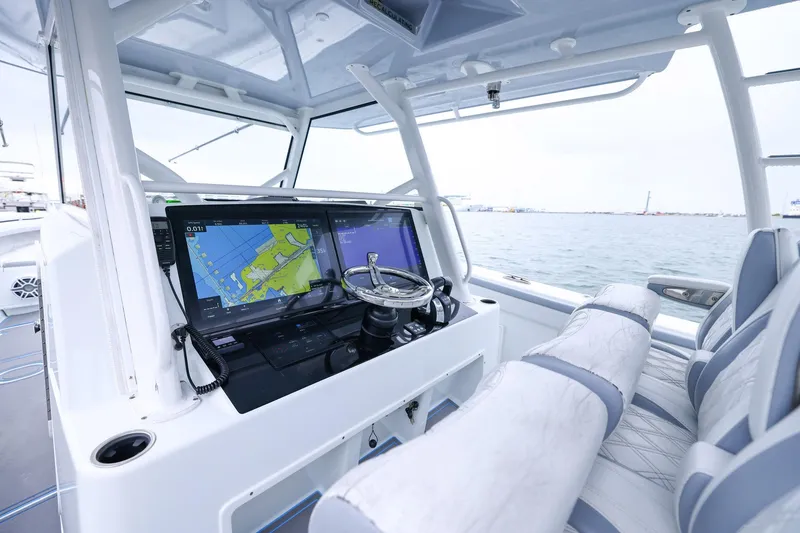 Slide: The Image of 2020 Yellowfin 42 Offshore boat cockpit with navigation screens and steering wheel. - 16
