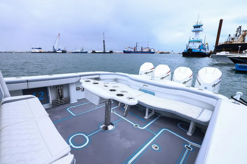 Slide: The Image of 2020 Yellowfin 42 Offshore boat with spacious seating, docked in a busy harbor. - 19