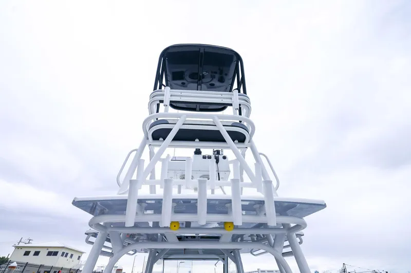 Slide: The Image of 2020 Yellowfin 42 Offshore boat tower against cloudy sky, showcasing sleek design. - 21