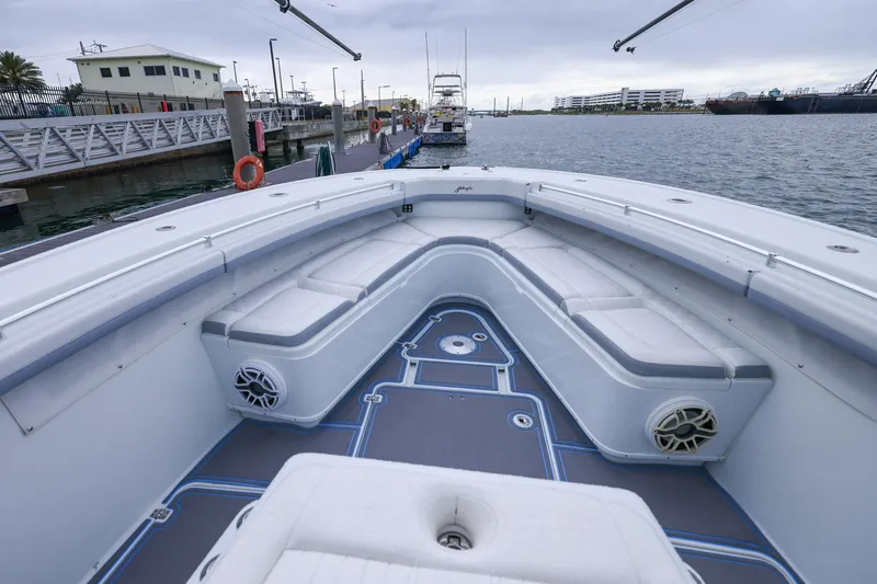 Slide: The Image of 2020 Yellowfin 42 Offshore boat interior with cushioned seating at dock. - 24
