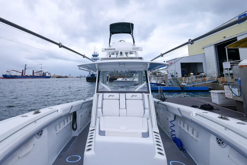 Slide: The Image of 2020 Yellowfin 42 Offshore boat docked at a marina, showcasing spacious deck and seating. - 26