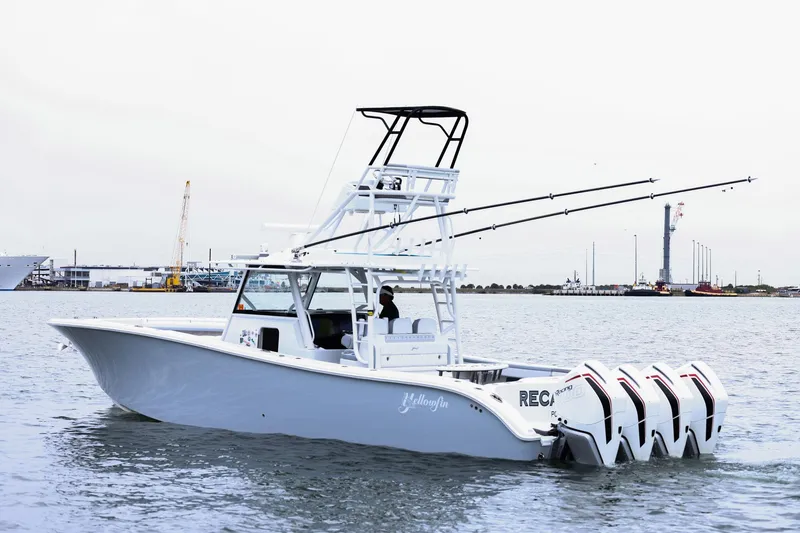 Slide: The Image of 2020 Yellowfin 42 Offshore boat with multiple outboard engines on calm water. - 3