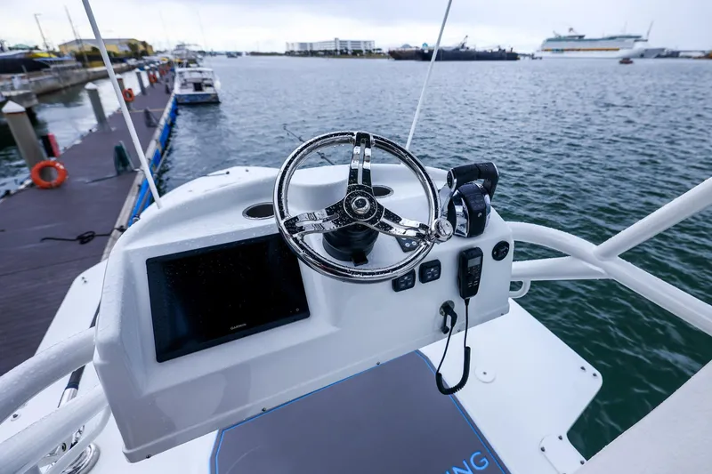 Slide: The Image of Helm of 2020 Yellowfin 42 Offshore boat docked at marina. - 32