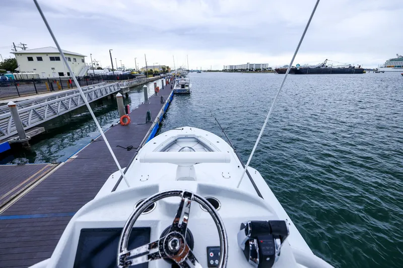 Slide: The Image of 2020 Yellowfin 42 Offshore boat docked at marina, view from helm. - 33