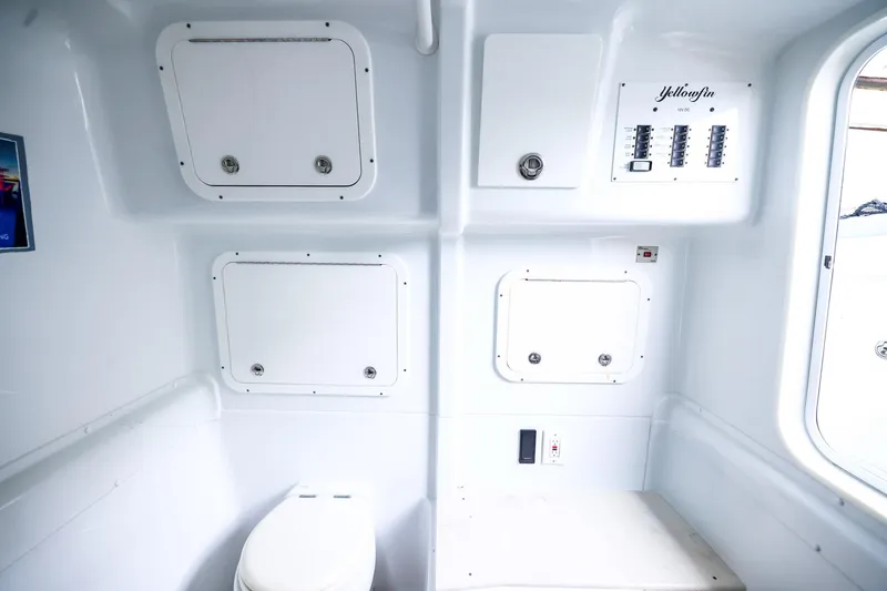 Slide: The Image of 2020 Yellowfin 42 Offshore boat interior with storage compartments and control panel. - 38