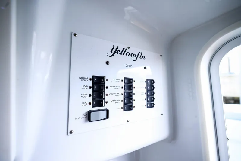 Slide: The Image of Control panel of a 2020 Yellowfin 42 Offshore boat, featuring various switches. - 39