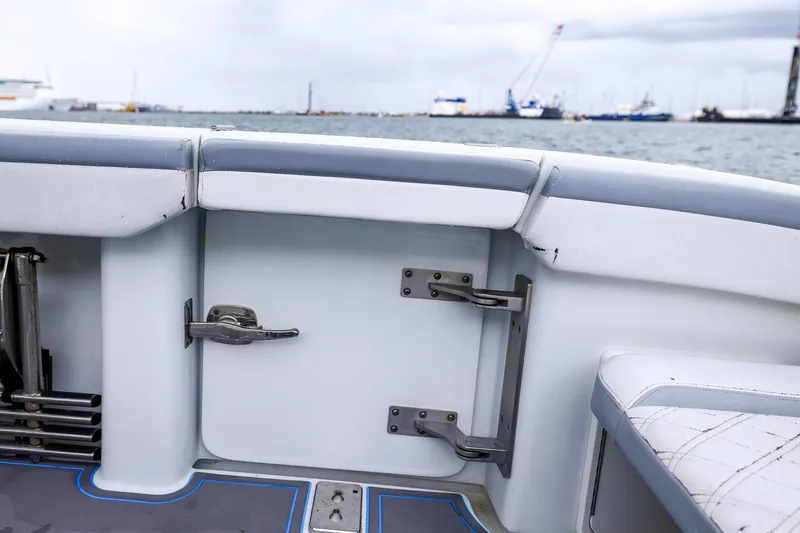 Slide: The Image of 2020 Yellowfin 42 Offshore boat interior with seating and hardware, overlooking a harbor. - 42