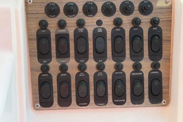 Slide: The Image of Control panel of a 1996 Grady-White Sailfish 272 boat with labeled switches. - 17