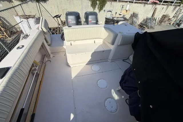 Slide: The Image of 1996 Grady-White Sailfish 272 boat deck with seating and dual outboard engines. - 18