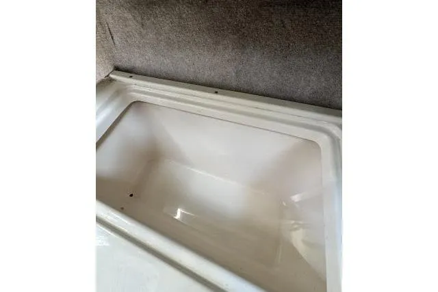 Slide: The Image of Interior compartment of 1996 Grady-White Sailfish 272 boat, featuring a clean storage area. - 26