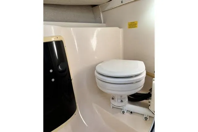 Slide: The Image of 1996 Grady-White Sailfish 272 boat interior with compact marine toilet. - 29
