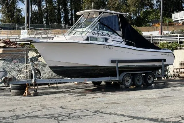 Slide: The Image of 1996 Grady-White Sailfish 272 boat on trailer, parked outdoors. - 3