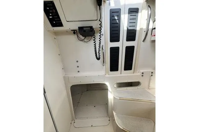 Slide: The Image of Interior view of a 1996 Grady-White Sailfish 272 boat cabin with steps and control panel. - 31