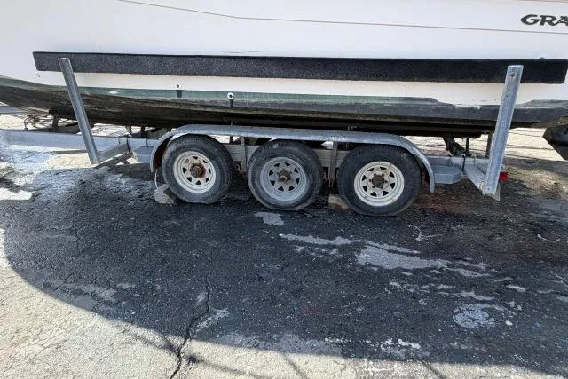 Slide: The Image of Trailer for 1996 Grady-White Sailfish 272 boat on asphalt surface. - 34