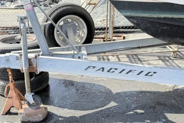 Slide: The Image of Trailer for 1996 Grady-White Sailfish 272 boat, labeled "Pacific," on a sunny day. - 35