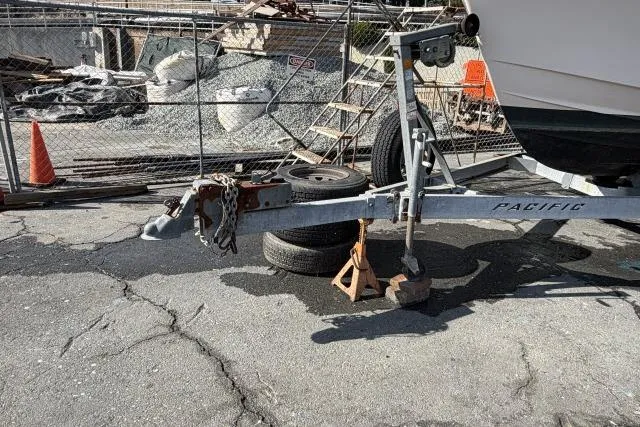 Slide: The Image of Trailer for 1996 Grady-White Sailfish 272 boat, parked on cracked pavement. - 36