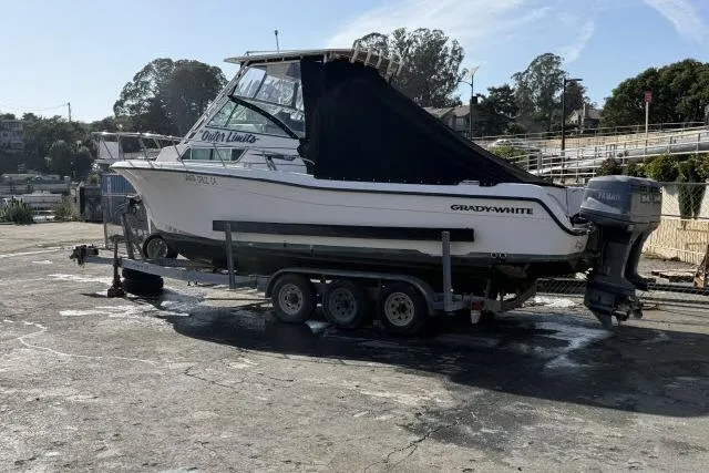 Slide: The Image of 1996 Grady-White Sailfish 272 boat on trailer, parked outdoors. - 4