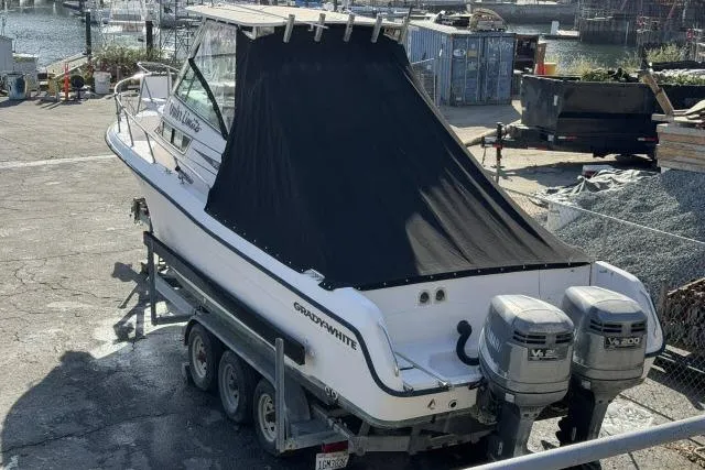 Slide: The Image of 1996 Grady-White Sailfish 272 boat on trailer with twin outboard motors. - 7