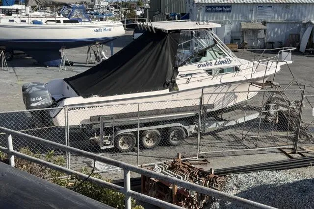 Slide: The Image of 1996 Grady-White Sailfish 272 boat on trailer, covered, in a marina storage area. - 9