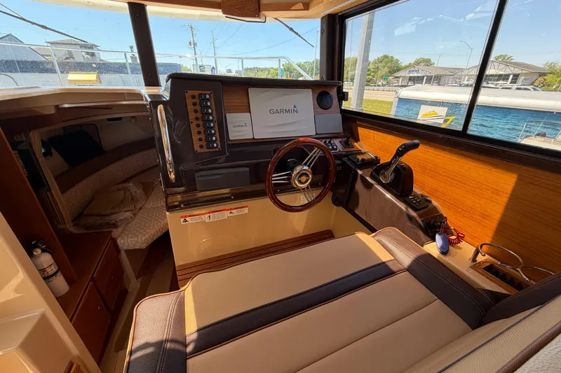 Slide: The Image of 2018 Ranger Tugs R-27 boat interior with Garmin navigation system and cozy cabin. - 11