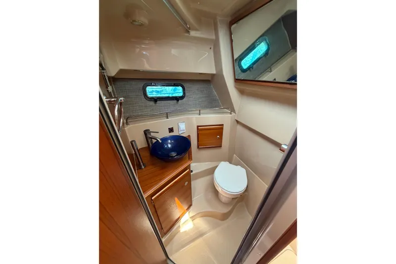 Slide: The Image of 2018 Ranger Tugs R-27 boat bathroom with modern sink and toilet. - 16