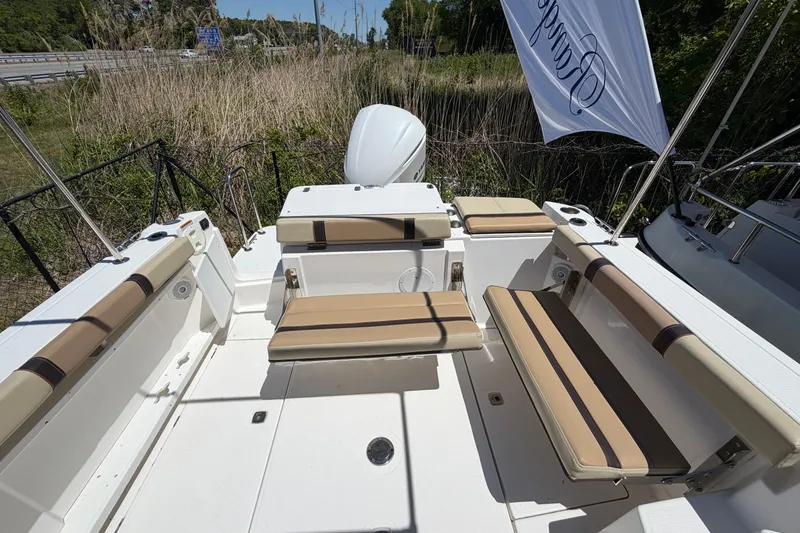 Slide: The Image of 2018 Ranger Tugs R-27 boat interior with beige seating and outdoor view. - 4