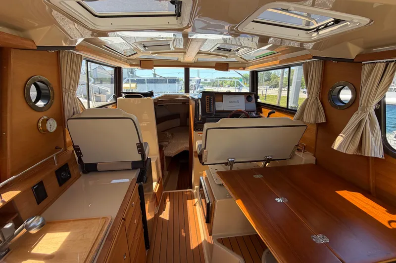 Slide: The Image of Interior of 2018 Ranger Tugs R-27 boat with wood finish and navigation equipment. - 6