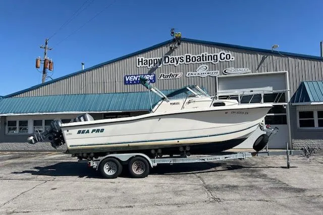 The Image of 2001 Seapro 235 WAC boat on trailer at Happy Days Boating Co. dealership. - 0