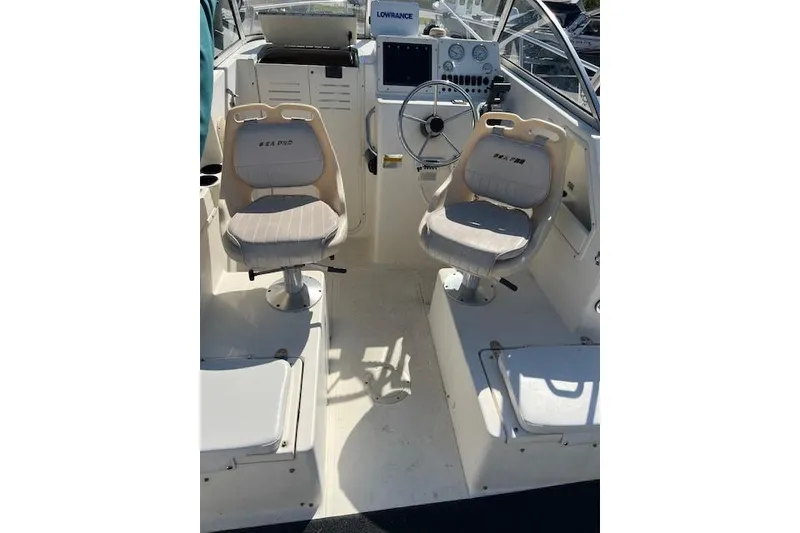 Slide: The Image of 2001 Seapro 235 WAC boat interior with steering wheel and two seats. - 10