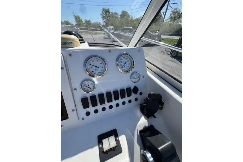 Slide: The Image of Seapro 235 WAC 2001 boat dashboard with gauges and controls in sunlight. - 5