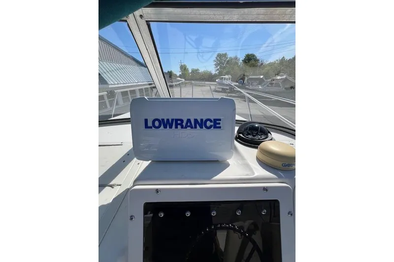 Slide: The Image of 2001 Seapro 235 WAC boat dashboard with Lowrance GPS and compass. - 6