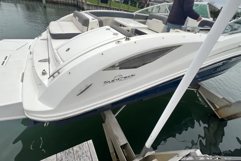 Slide: The Image of 2011 Sea Ray 300 Sundeck docked by a waterfront home with a pool. - 11